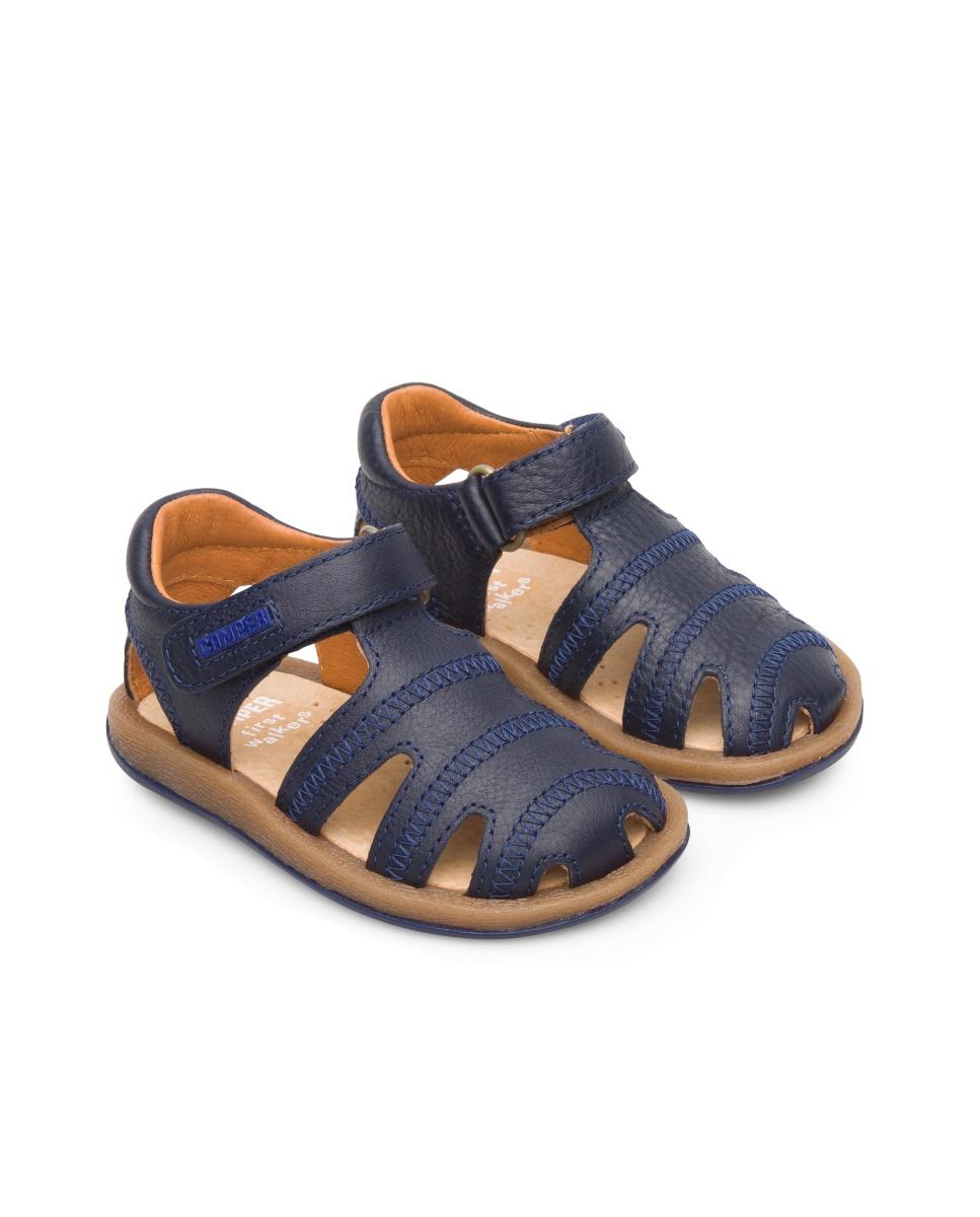Sandálias fechadas com tira em forma de T para criança. Pele flor e sola de EVA. A coleção Primeiros Passos inclui modelos flexíveis e ao mesmo tempo resistentes para ajudar os mais pequenos quando começam a andar. Sapatos desenhados para que as crianças desfrutem mais das suas primeiras aventuras a caminhar. As nossas sandálias Bicho para menino é ajustável e as suas palmilhas ergonómicas feitas de borracha e casca de arroz recicladas adaptam-se ao pé Camper Azul-marinho-2
