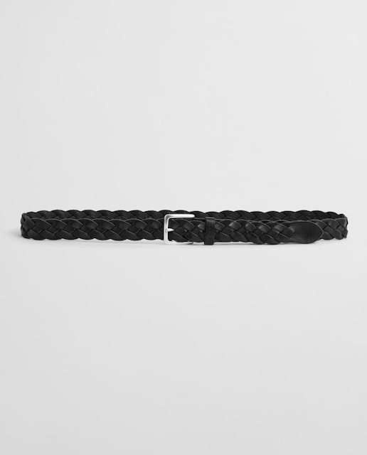 Imagen 0 de Cinturón trenzado de hombre en material flexible con detalles de piel, hebilla metálica y diseño versátil.