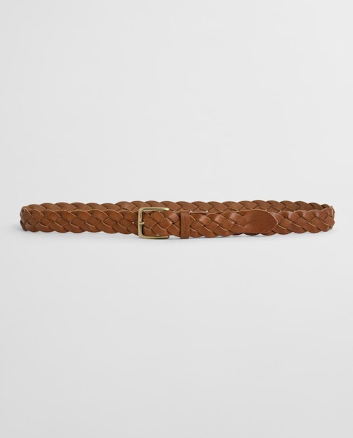 Imagen 0 de Cinturón trenzado de hombre en material flexible con detalles de piel, hebilla metálica y diseño versátil.