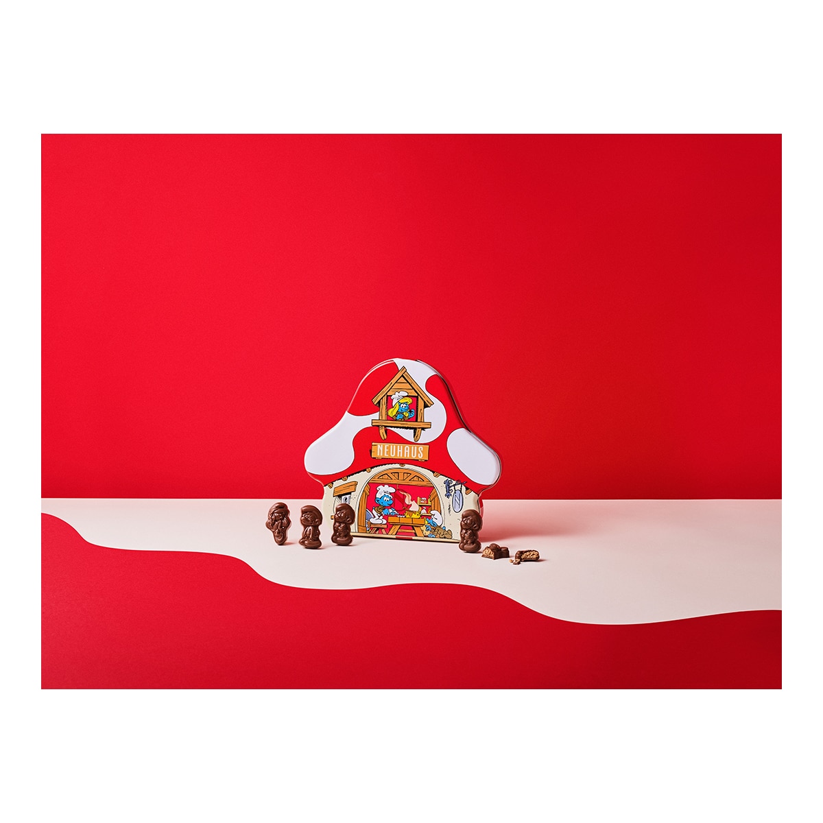 Bombones de chocolate con leche, crujiente de praliné con peta zeta casita de los Pitufos Neuhaus 24 piezas 3