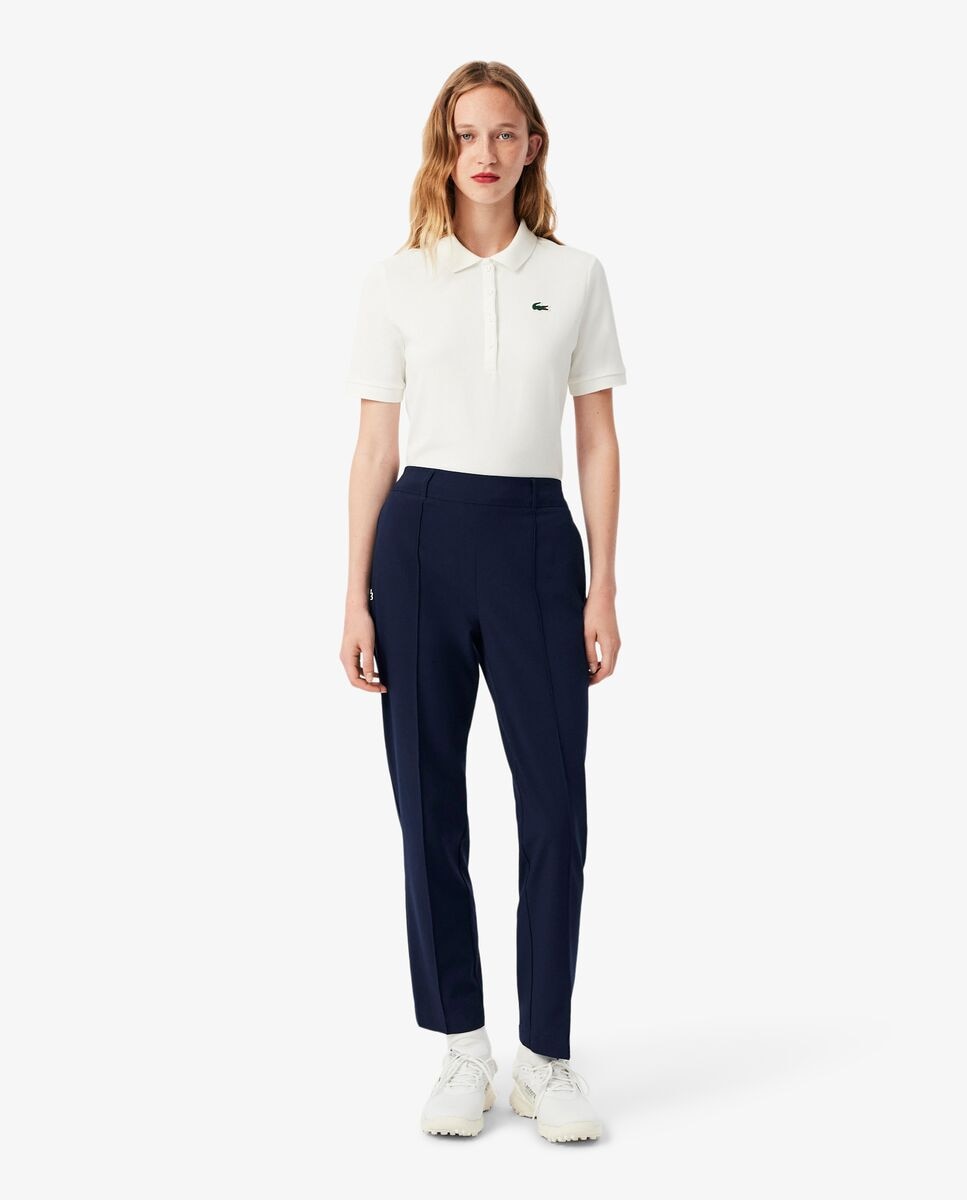 Lacoste - Pantalón de mujer de golf elástico de corte ajustado con protección UV en azul.