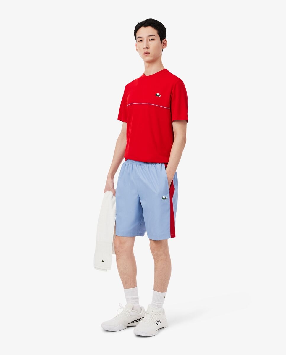 Lacoste - Pantalón de hombre corto deportivo con franja en contraste.