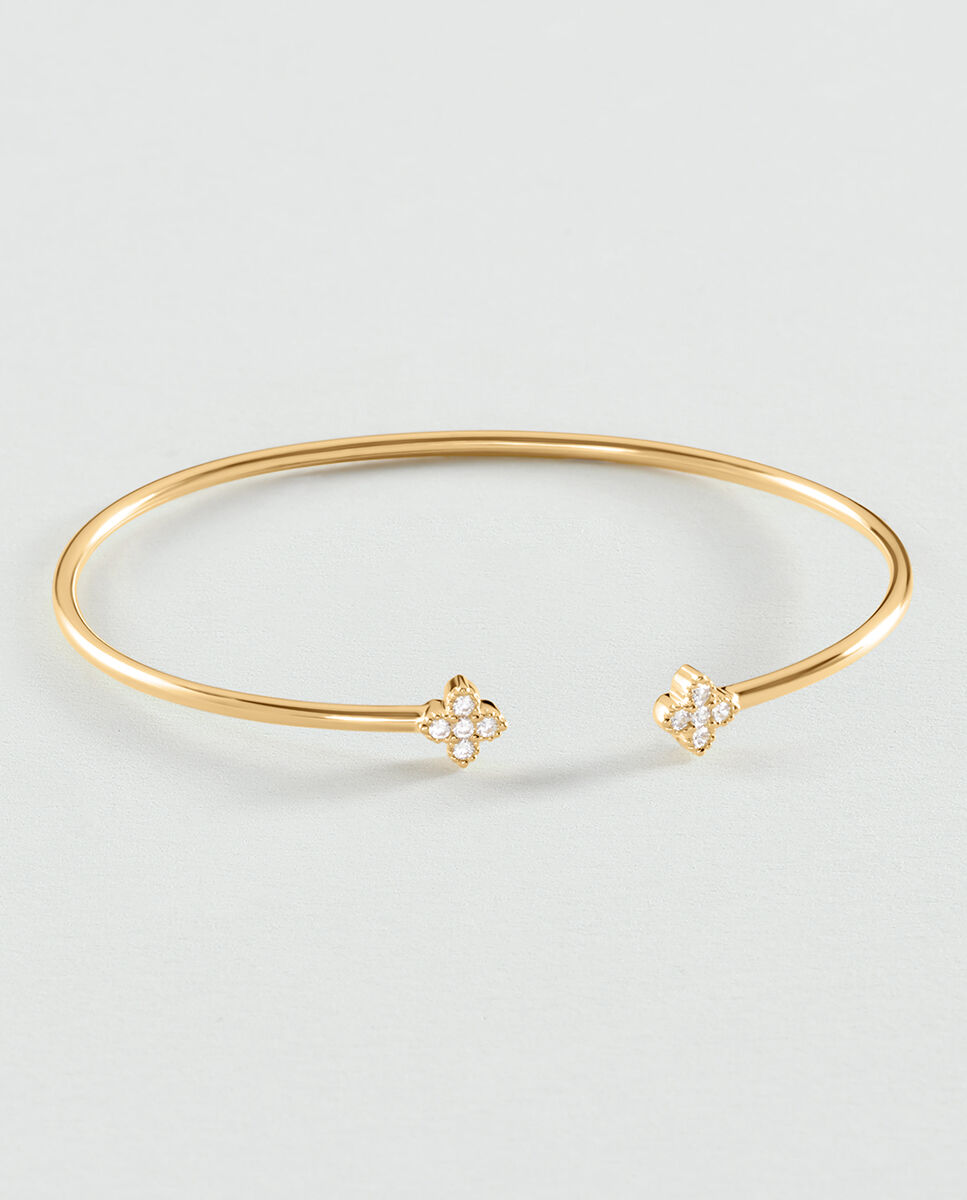 Imagen 0 de Pulsera beloved rígida y abierta de plata de ley y baño de oro con circonitas en forma de flor en los extremos
