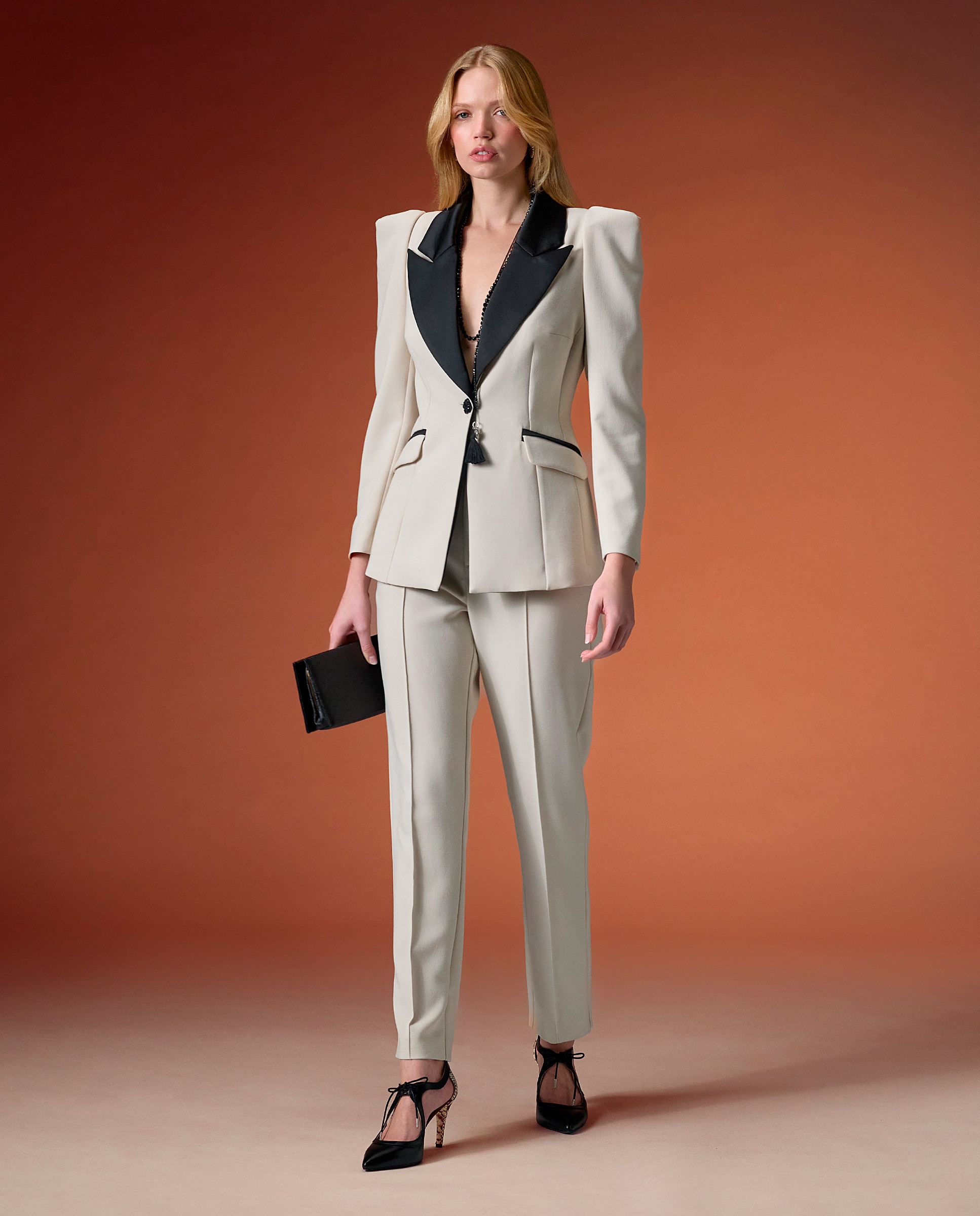 Imagen 0 de Conjunto chaqueta y pantalón bicolor en tono marfil con detalles negros. Crudo
