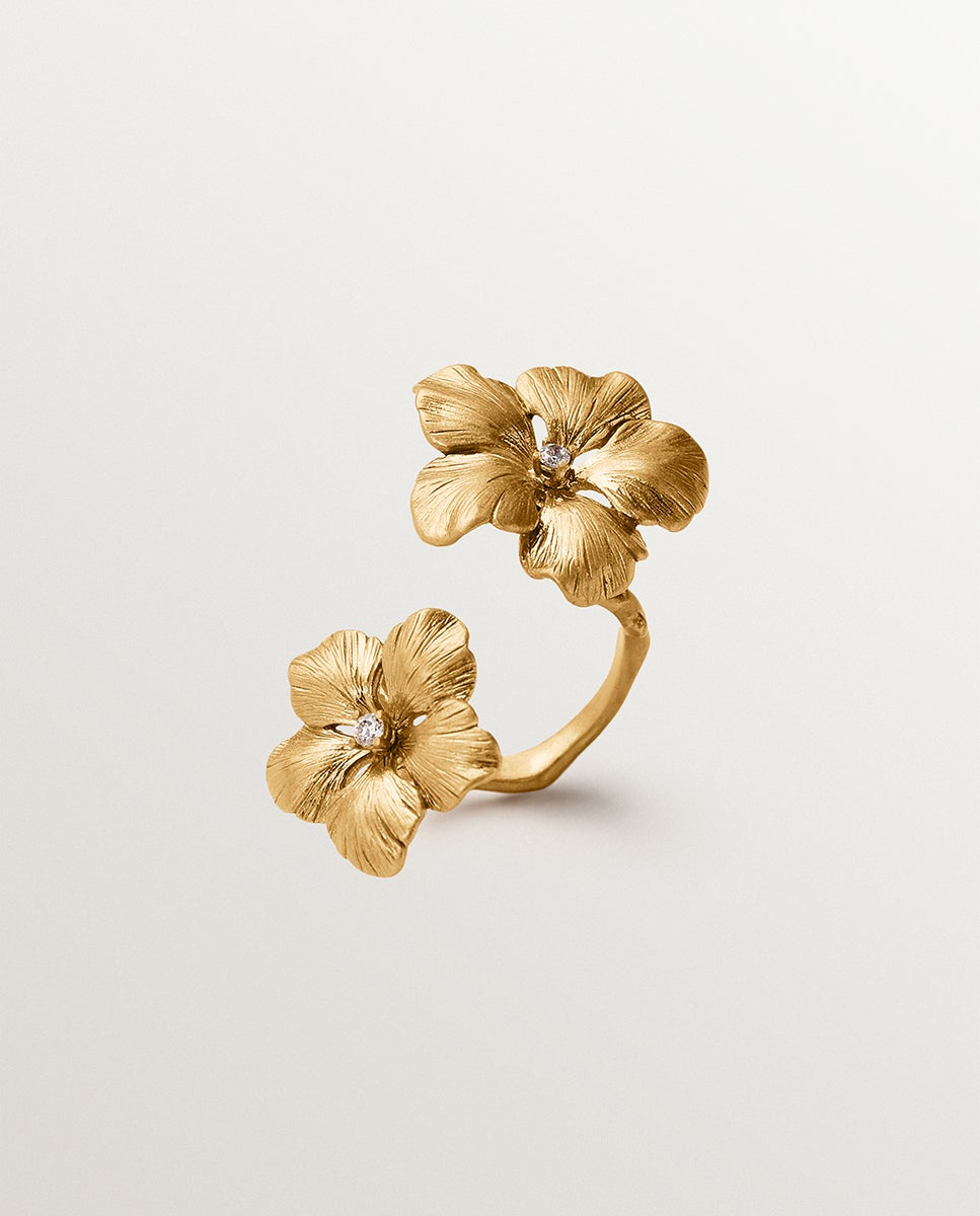 Imagen 0 de Anillo abierto bañado en oro amarillo con cristales y motivo de flor Blanco